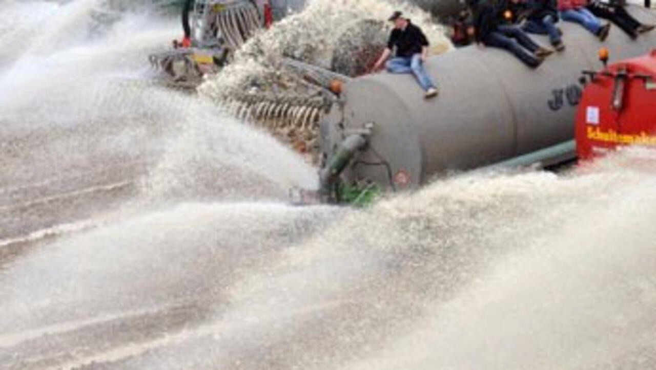 Desperate European farmers dump milk in massive protest