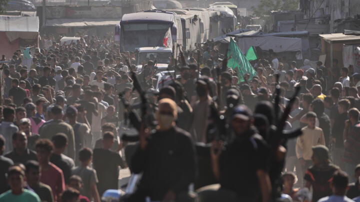 Hamas gunmen escort buses carrying freed Palestinian prisoners arriving in the Gaza Strip after their release from Israeli jails under a ceasefire agreement between Hamas and Israel, in Khan Younis.