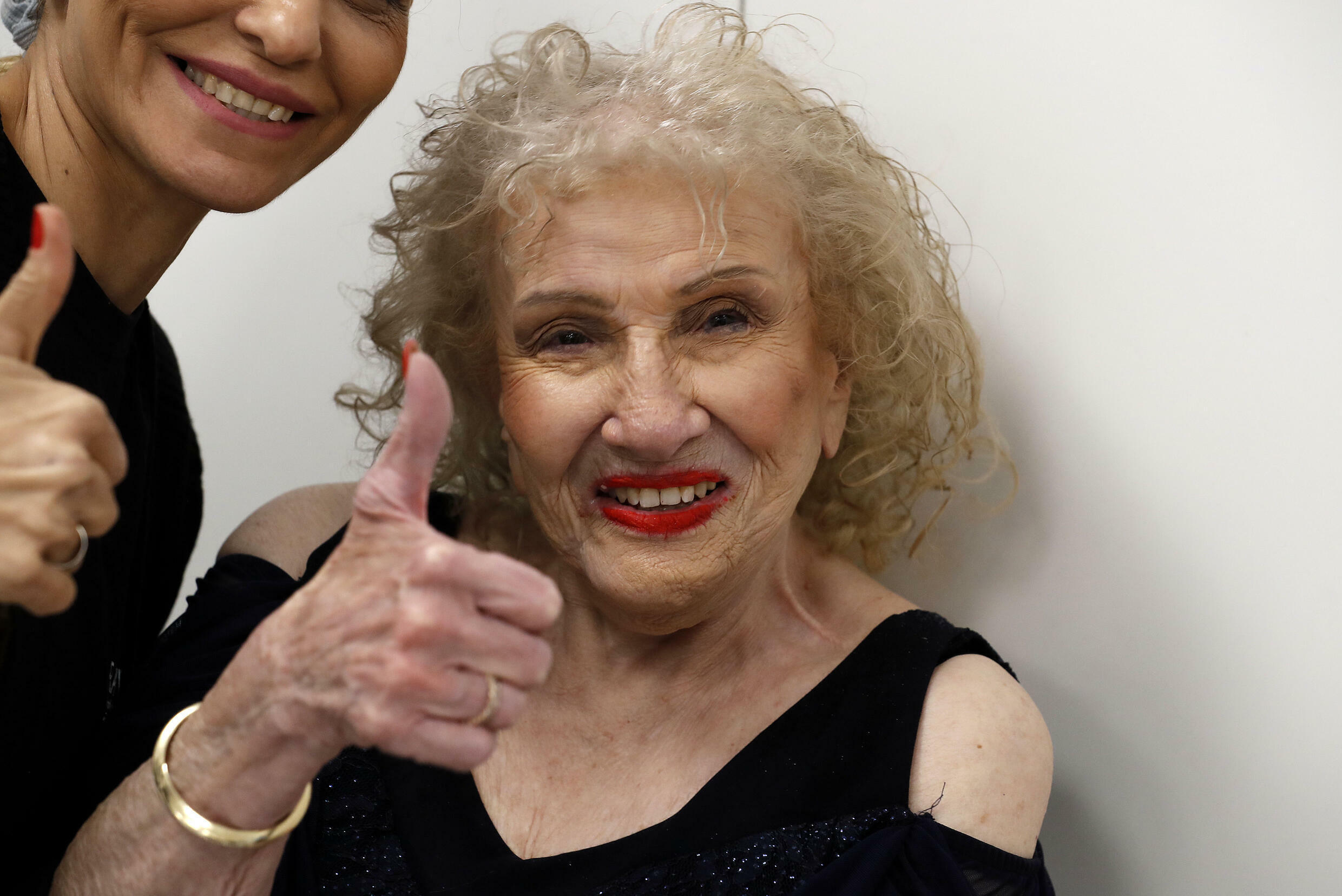 Holocaust survivor Chana Harel, 90, gives the thumbs up during the beauty pageant