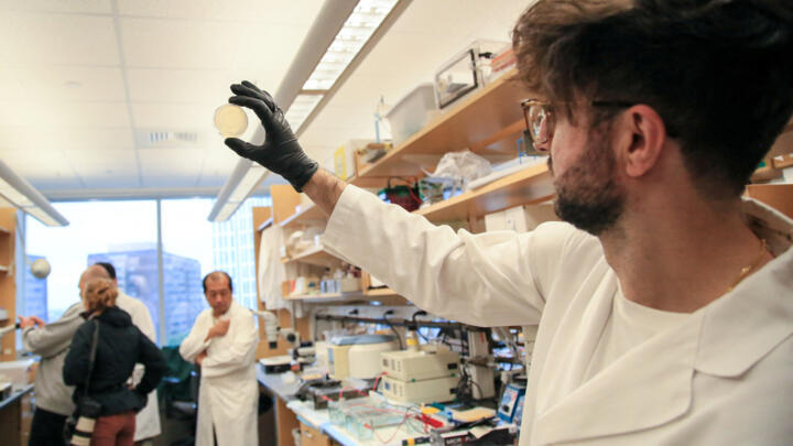 A researcher holds a plate of nematodes in the Ruvkun Lab in the Richard B. Simches Research Center at Massachusetts General Hospital in Boston, Massachusetts on October 7, 2024.