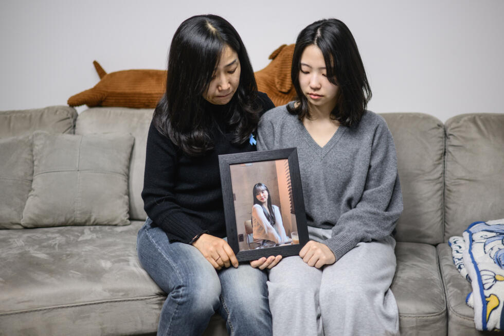 Lee Hyo-eun (L) and her daughter Park Chae-won sit at home with a portrait of Lee's other daughter and Park's sister Ye-won, who died along with 178 others in the Jeju Air Flight 2216 plane crash