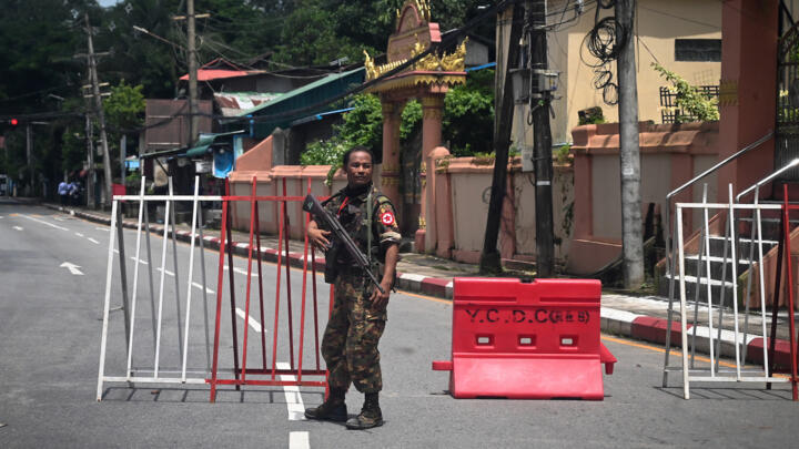 A member of the Myanmar security forces stands by a checkpoint in Yangon on July 19, 2022, on the 75th Martyrs' Day that marks the anniversary of the assassination of independence leaders including general Aung San, father of the currently ousted and imprisoned leader Aung San Suu Kyi.