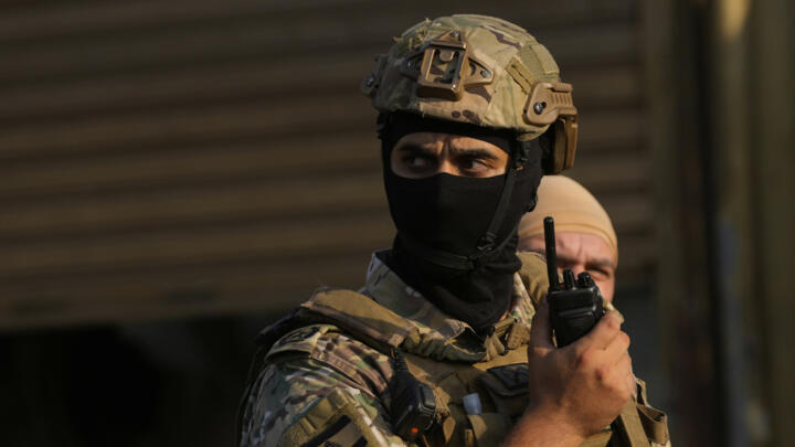 This file photo shows a Lebanese army officer speaking on his radio in Beirut on August 21, 2025. 