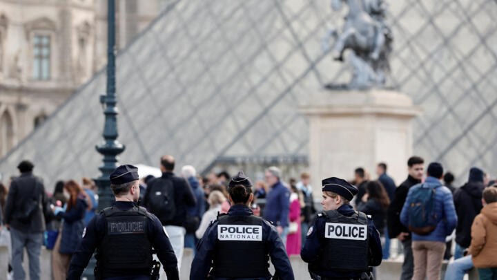 French police patrol near the Louvre Museum pyramid on October 20, 2025, after a spectacular jewel heist by thieves.