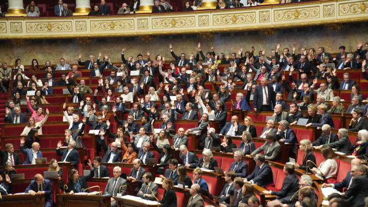 Parliament members vote at the National Assembly during a debate on social security financing bill, Wednesday, November 12, 2025 in Paris.