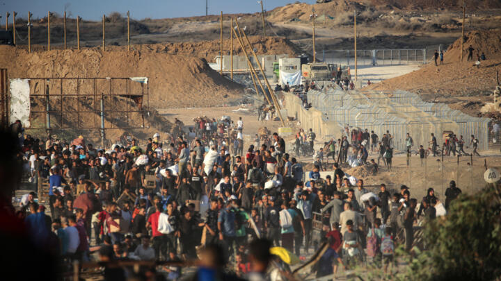Palestinians gather at an aid distribution point set up by the privately-run Gaza Humanitarian Foundation (GHF), near the Nuseirat refugee camp in the central Gaza Strip on June 25, 2025.