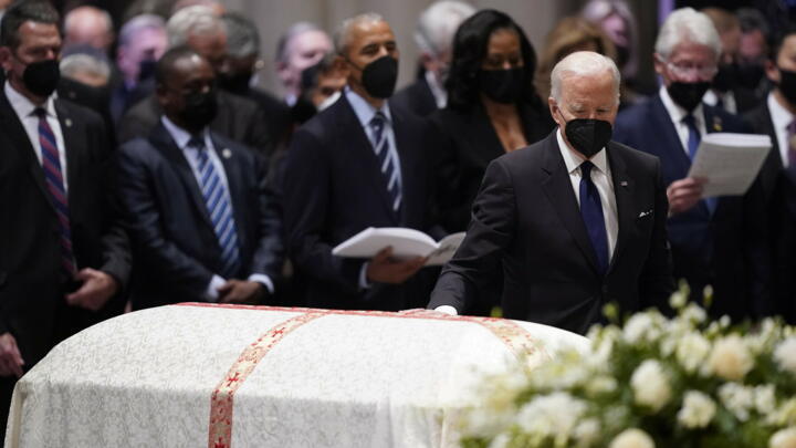 President Joe Biden places his hand on the casket of former Secretary of State Madeleine Albright during the funeral service at the Washington National Cathedral on Wednesday.