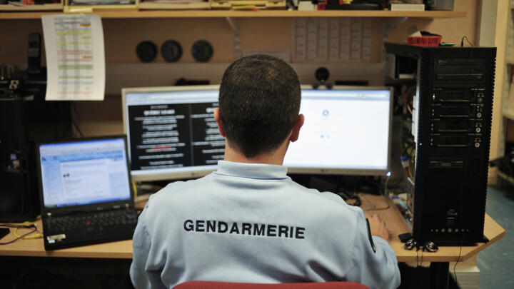 A police officer in the cybercrime unit works at Dijon police station on February 21, 2011.