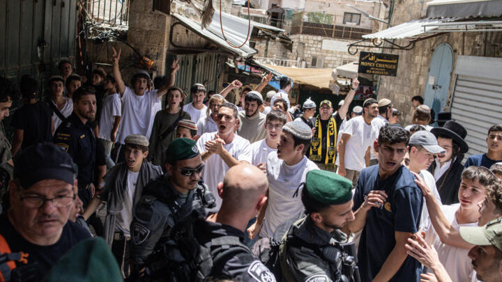 Israeli right-wing activists chant slogans in Jerusalem's Old City during a flag march for Jerusalem Day on May 26, 2025.