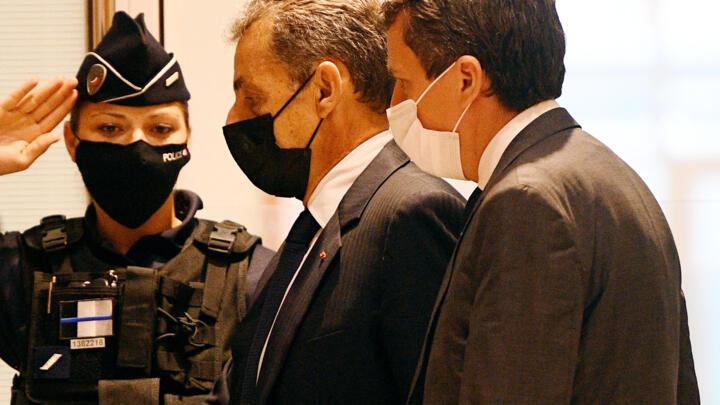 Ex-French President Nicolas Sarkozy (c) arrives at court in Paris, June 15, 2021.