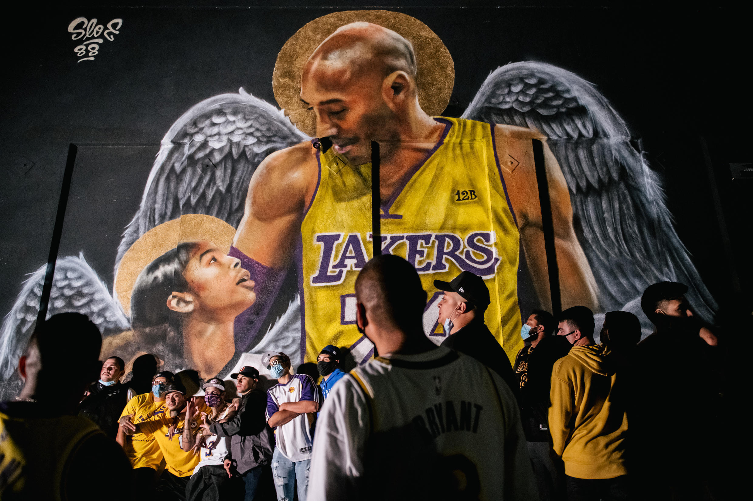 Lakers fans stand in line to celebrate the team's NBA Finals win in front of a mural of Kobe Bryant and his daughter Gianna on October 11.