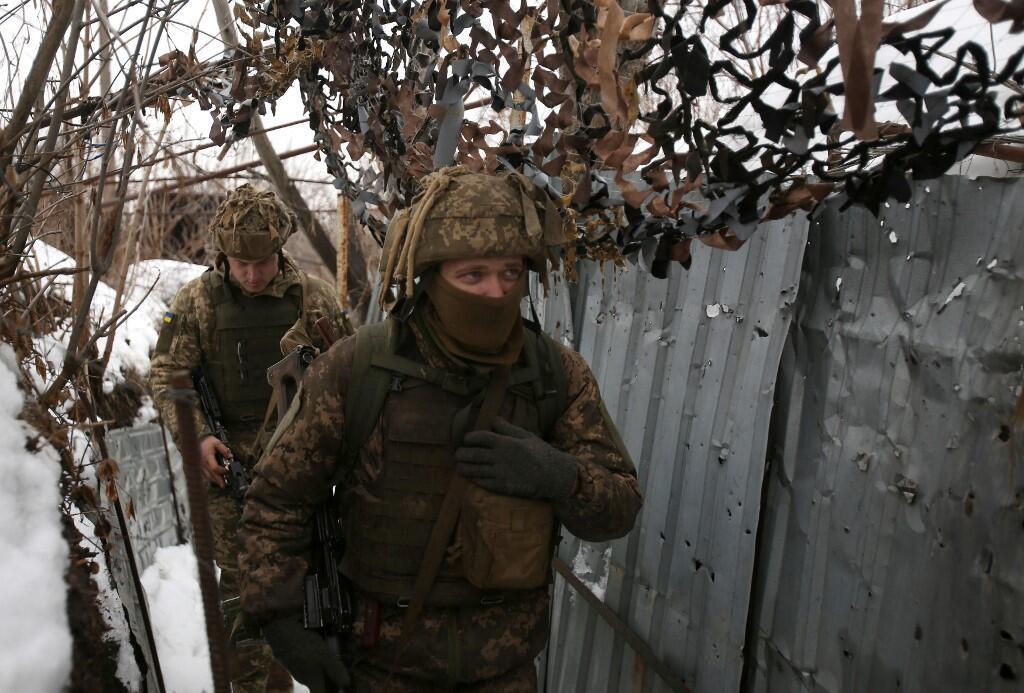 Los militaria cranian caminan a lo trinchera cubierta nieve en la linea del freente con los separatistas respaldados por avadivika, regia dontsk, 2 lutego 2022 r.