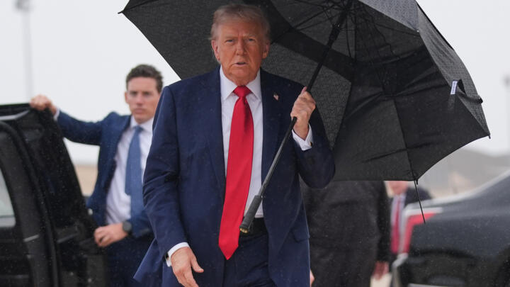 President Donald Trump walks over to speak with reporters before boarding Air Force One, Sunday, October 12, 2025.