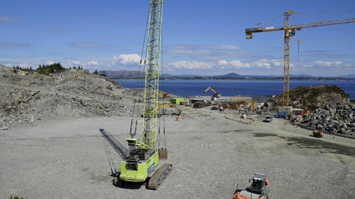 A photo taken on June 21, 2021 in Oygarden near Bergen, Norway, shows cranes and vehicles at the start of construction work for a terminal that will collect liquefied carbon dioxide.