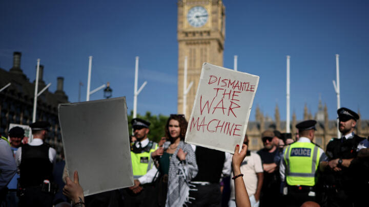 Protesters hold placards at a "Lift The Ban" demonstration in support of the proscribed group Palestine Action, calling for the recently imposed ban to be lifted, in Parliament Square, central London,