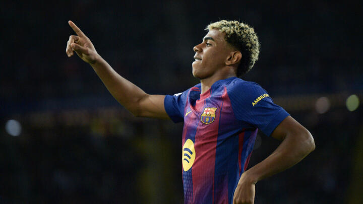 Barcelona's Spanish forward #10 Lamine Yamal celebrates after converting a penalty to score their third goal during the UEFA Champions League league phase match-day 3 match between FC Barcelona and Ol
