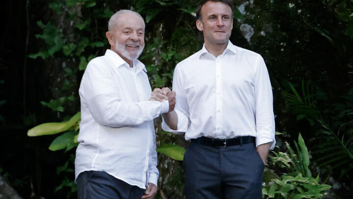 Brazilian President Luiz Inacio Lula Da Silva and French President Emmanuel Macron react on arrival at Combu Island, in front of Belem, state of Para, Brazil, on March 26, 2024.