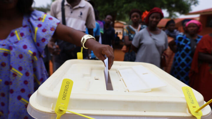 A woman casts her vote during the presidential and legislative elections, in Bissau, Guinea-Bissau, Sunday, Nov. 23, 2025.
