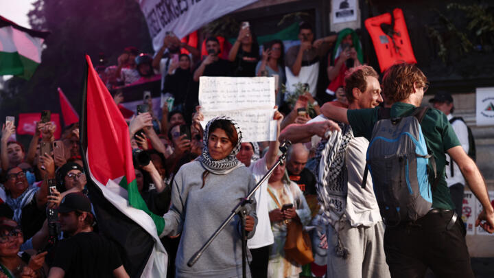 French-Palestinian lawyer and member of European Parliament Rima Hassan holds a Palestinian flag upon arriving to join a rally in her support at Place de la Republique in Paris on June 12, 2025.