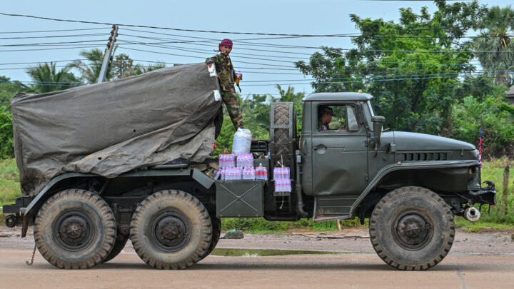 A Cambodian soldier stands on a truck carrying a Russian-made BM-21 rocket launcher in Oddar Meanchey province on July 26, 2025.
