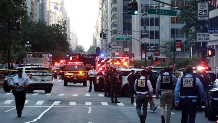 Police officers and emergency vehicles are seen in a street as police respond to a shooting incident in the Midtown Manhattan neighborhood of New York on July 28, 2025.