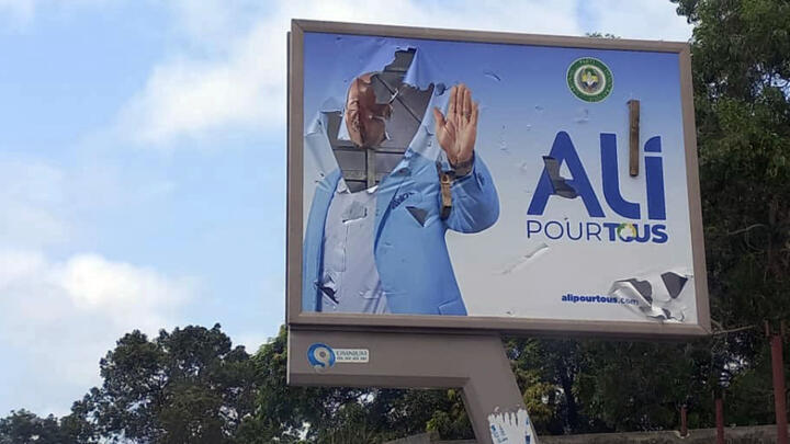 A defaced billboard of Gabon's President Ali Bongo is displayed on an empty street in Libreville, Gabon, on August 30, 2023.