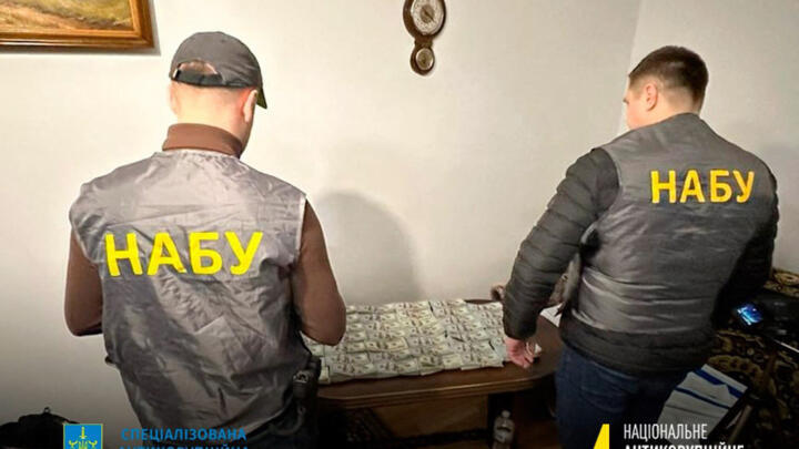 A handout photograph published on January 23, 2023 by the National Anti-Corruption Bureau of Ukraine, shows NABU staff members next to seized money.