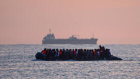 A file photo showing a group of migrants on an inflatable dinghy leaving the coast of northern France in an attempt to cross the English Channel to reach Britain.