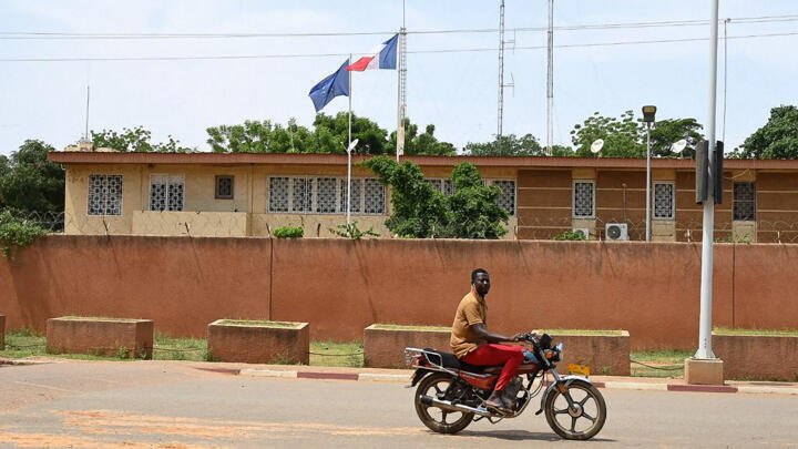 A man rides his motorbike past the French Embassy in Niamey, Niger on August 28, 2023.