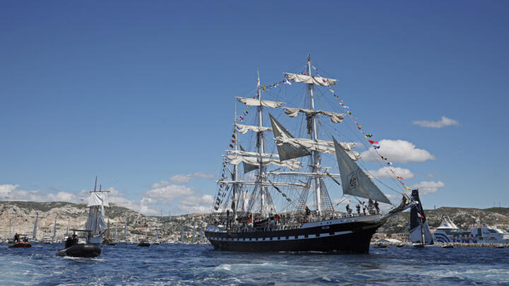 The "Belem", a three-masted sailing ship carrying the Olympic Flame, sails to Marseilles’s Old Port ahead of the 2024 Paris Olympics.
