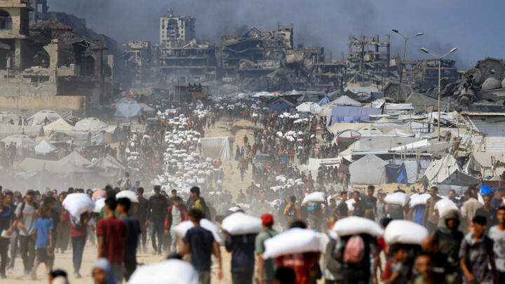 Palestinians gather to collect aid supplies in Beit Lahia in the northern Gaza Strip on July 20, 2025.
