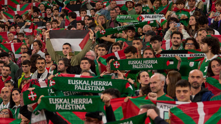 Fans wave Palestinian flags and flags of the northern Basque Country region during a friendly match between a selection of Palestinian players and a group of Spanish players from the Basque Country, held to protest Israel's military actions in Gaza, in Bilbao, Spain, Saturday, November 15, 2025.