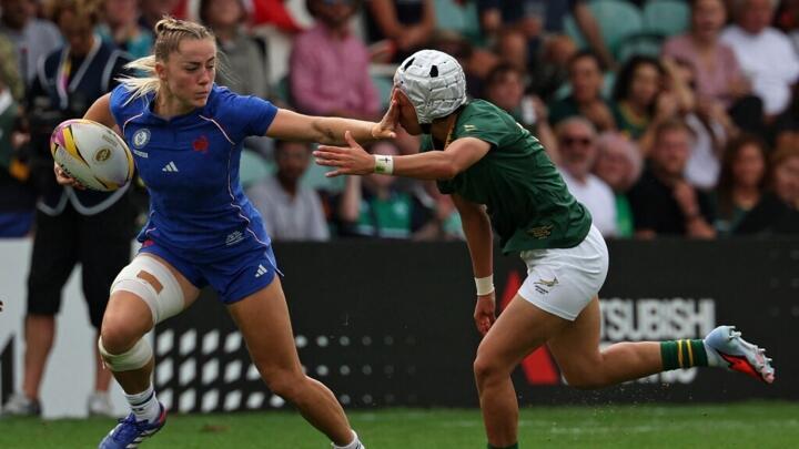 France's wing Joanna Grisez hands off South Africa's full back Byrhandré Dolf during the Womens Rugby World Cup pool D match between France and South Africa at Franklin's Gardens, Northampton.