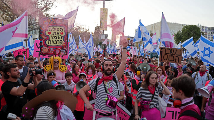 Protesters march amid demonstrations against the Netanyahu government's judicial reform bill in Tel Aviv, April 15, 2023