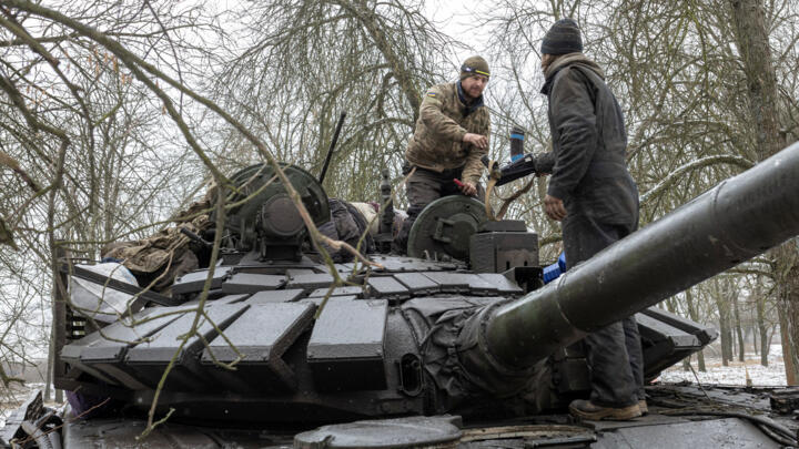 Ukrainian servicemen stand on a tank in the eastern Donetsk region on February 4, 2023.