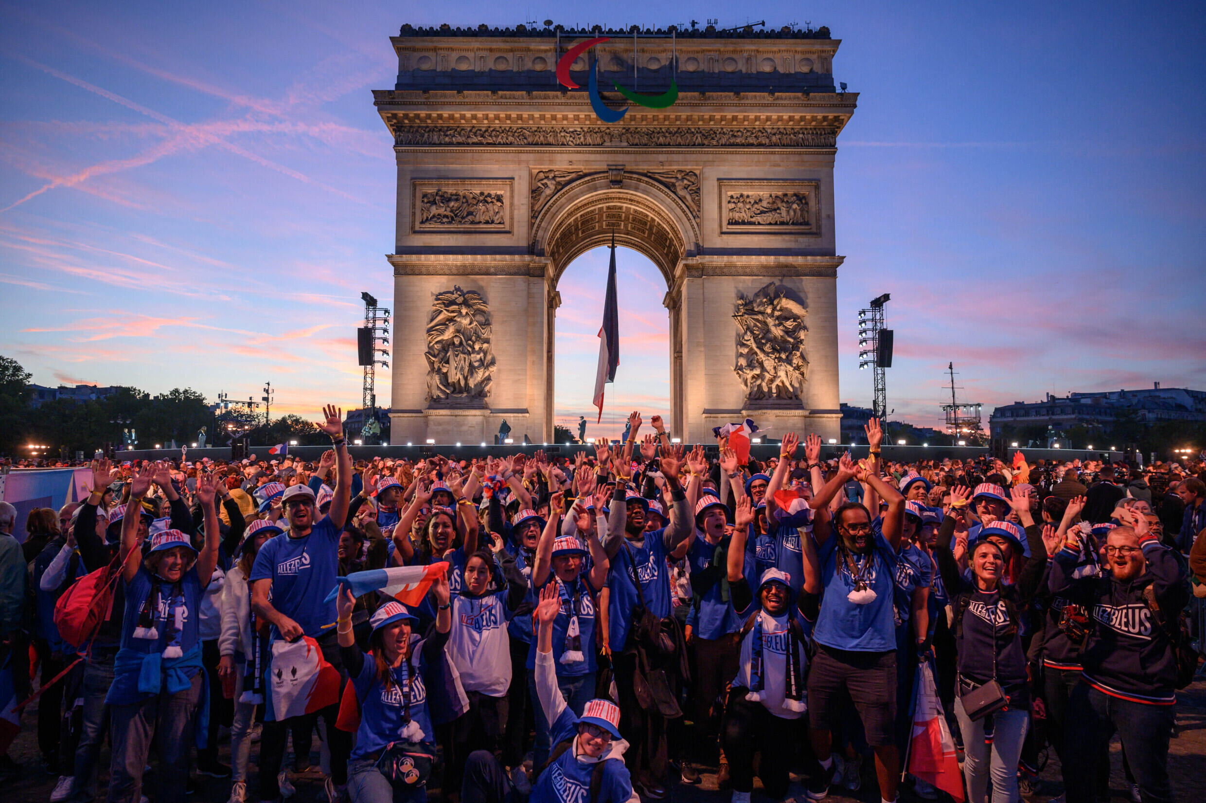 Des supporters devant l'Arc de Triomphe à la fin du défilé des athlètes français ayant participé aux Jeux olympiques et paralympiques de Paris 2024, à Paris, le 14 septembre 2024.
