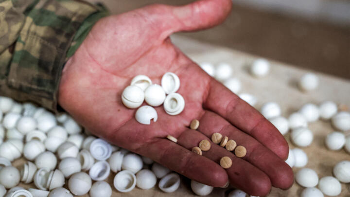 A Syrian rebel fighter inspects pills of captagon produced at a makeshift lab facility in the town of al-Dimas about 27 kilometres northwest of Damascus on December 22, 2024.