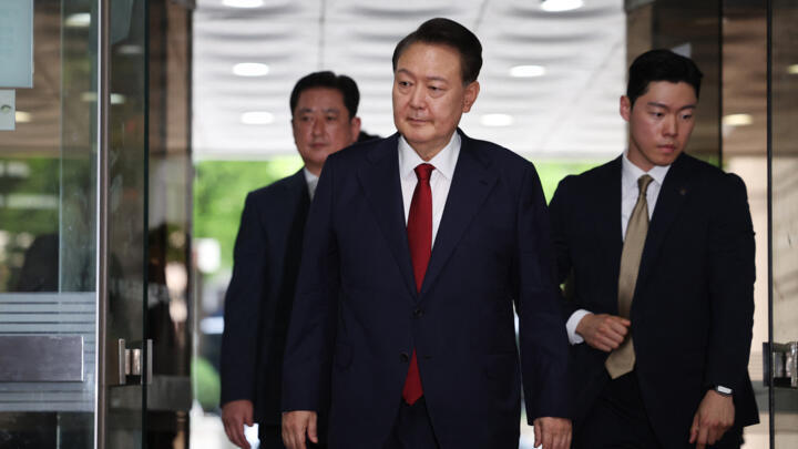 South Korea's former impeached president Yoon Suk Yeol (C) arrives at a court to attend a hearing to review his arrest warrant requested by special prosecutors, in Seoul on July 9, 2025.