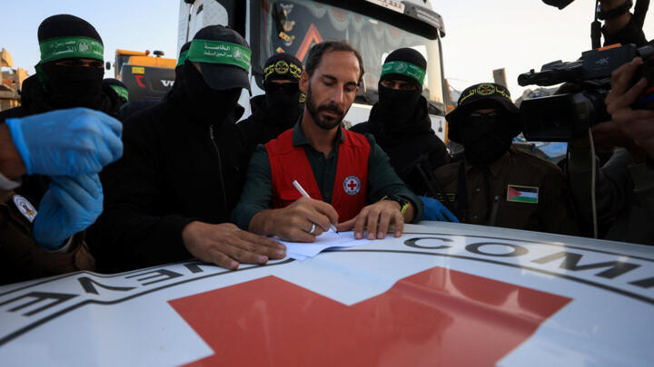A Red Cross member receives a body recovered by Palestinian Hamas and Islamic Jihad militants before it is handed over to Israel in Beit Lahiya in Gaza in December 2025. 