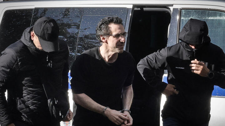 French researcher Laurent Vinatier is escorted to a court in Moscow on August 25, 2025, facing charges of "espionage".