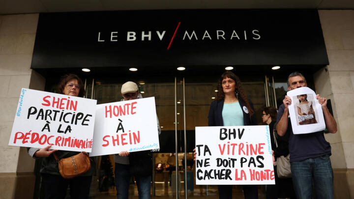 People protest against the sale of child-like sex dolls by Chinese fast-fashion retailer Shein during a demonstration in front of the  BHV Marais department store in Paris, November 3, 2025. The sloga