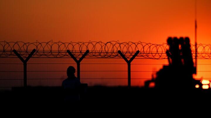 A woman runs past the Rzeszow-Jasionka airport, where Patriot air defence systems are installed at the military hub for Ukraine, in Jasionka, south-east Poland on March 6, 2025.