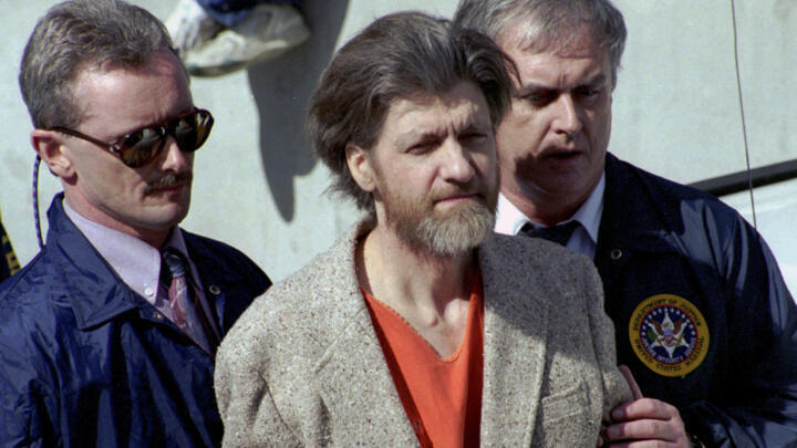 Theodore 'Ted' Kaczynski is flanked by federal agents as he is led to a car from the federal courthouse in Helena, Montana on April 4, 1996. 