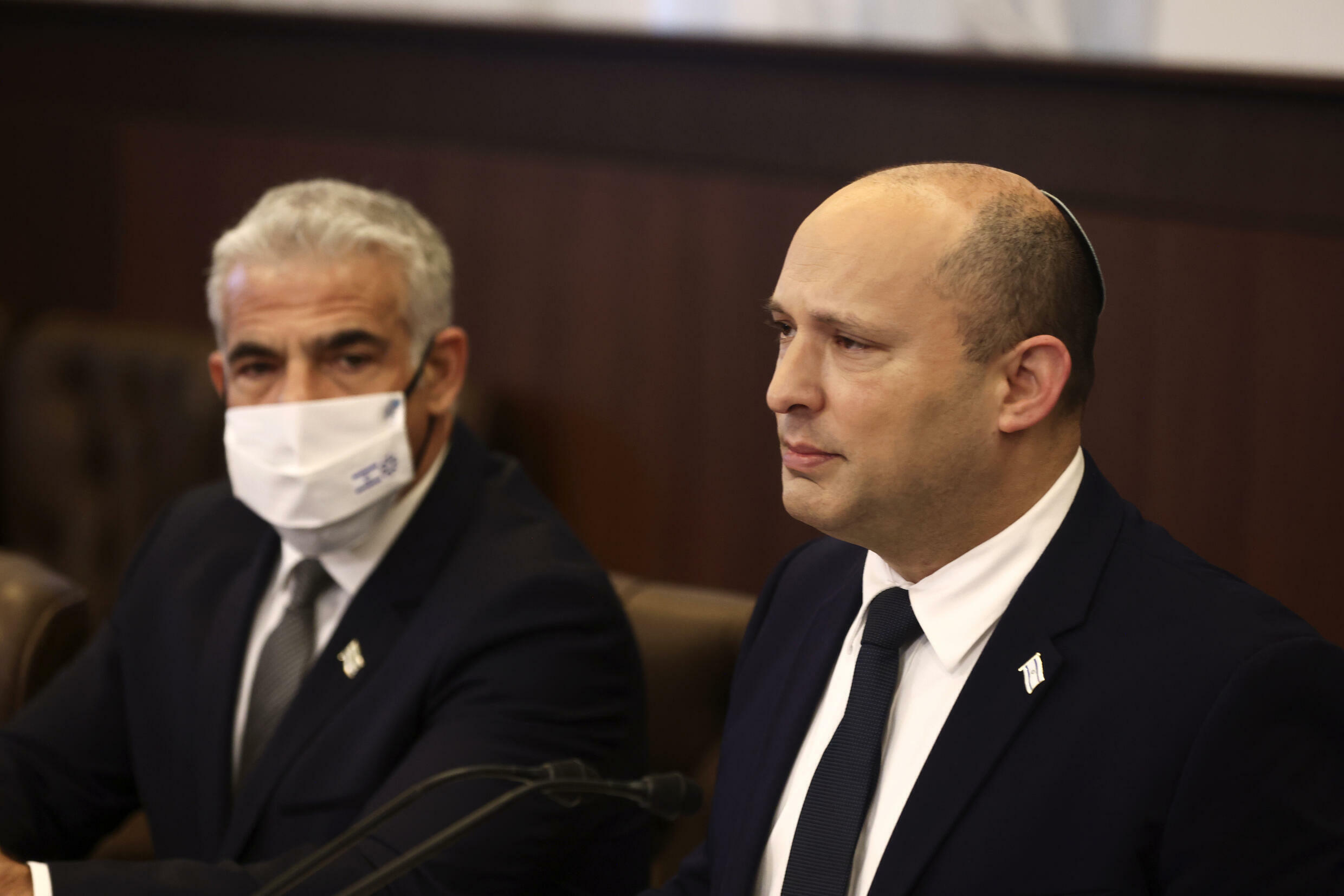 Israeli Prime Minister Naftali Bennett, right, sits next to Foreign Minister Yair Lapid at a weekly cabinet meeting at the Prime Minister's office in Jerusalem on November 3, 2021