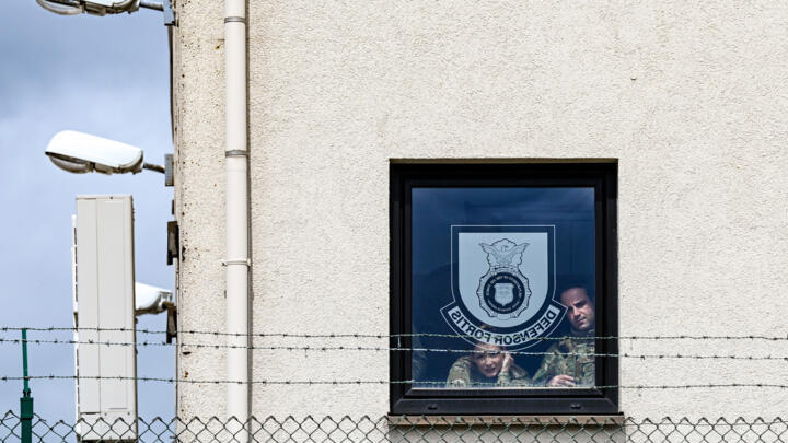 US Air Force Airmen watch from a window during Vice President JD Vance's visit to the Ramstein Air Base, Germany, April 24, 2025.