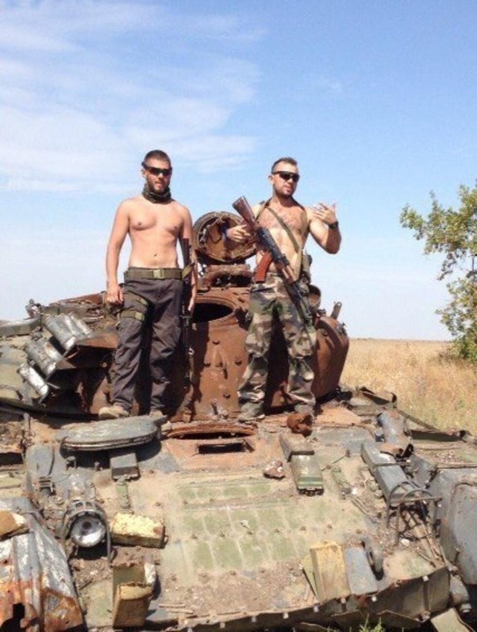Sergei Munier (left) is a French soldier fighting for Russia. He originally posted this photo of himself posing on an armoured vehicle on Facebook on October 8, 2015.
