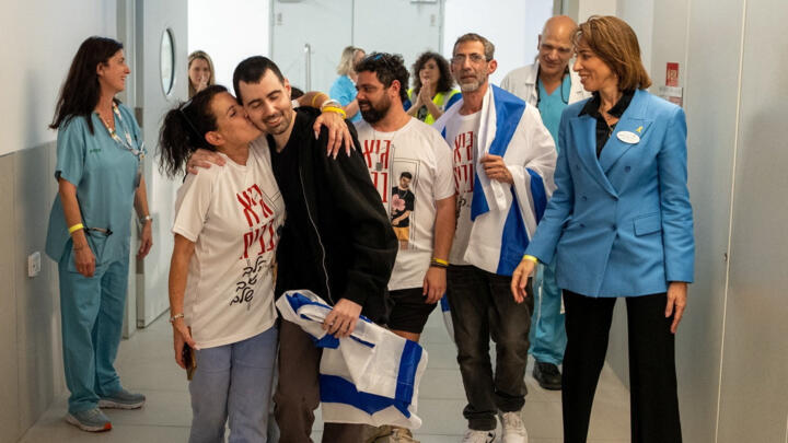 Released Israeli hostage Guy Gilboa-Dalal is embraced by a loved one at the Rabin Medical Center in Petah Tikva, Israel, on October 13, 2025.