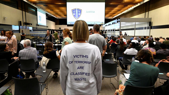 A member of the United organisation of Victims waits for the reading of sentences in the trial of eight men found guilty of participation or complicity in the March 2016 attacks in Brussels, on September 15, 2023.