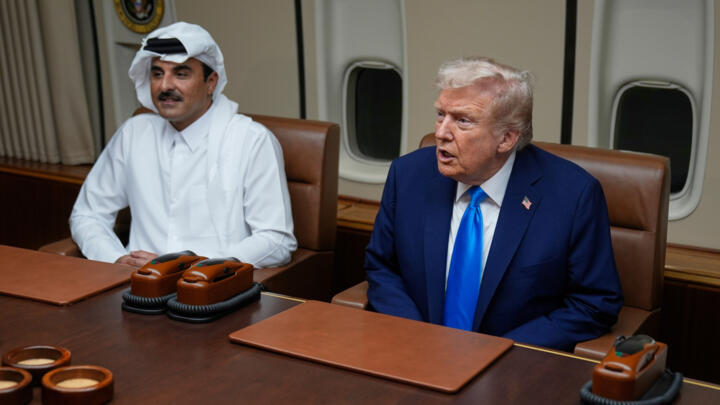 President Donald Trump, right, meets with Emir of Qatar Sheikh Tamim bin Hamad al-Thani aboard Air Force One at Al Udeid Air Base in Doha, Qatar, Saturday, October 25, 2025.