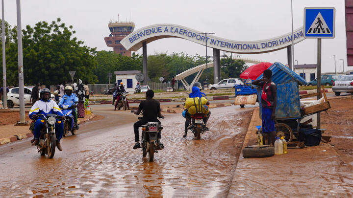 File photo of motorcyclists near the entrance of the airport in Niamey, Niger taken on August 8, 2023.